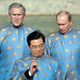 Hanoi, VIET NAM: US President George W. Bush (L), Russian President Vladimir Putin (R) and Chinese President Hu Jintao (C), all wearing a Vietnamese 'ao dai' silk tunic, speak as they take part in the official photograph for the Asian Pacific Economic Cooperation (APEC) summit in Hanoi, Vietnam 19 November 2006.